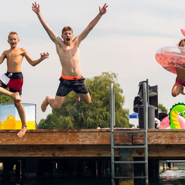 Kinder springen im Strandbad Klagenfurt in den Wörthersee